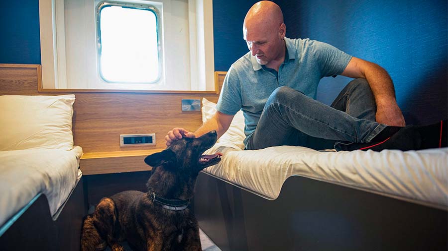 Dog with owner in a P&O Ferry dog cabin