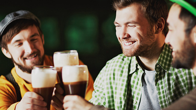 Irish bar - three guys drinking pints of beer in a bar